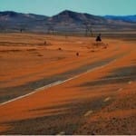 desert sand blowing over road